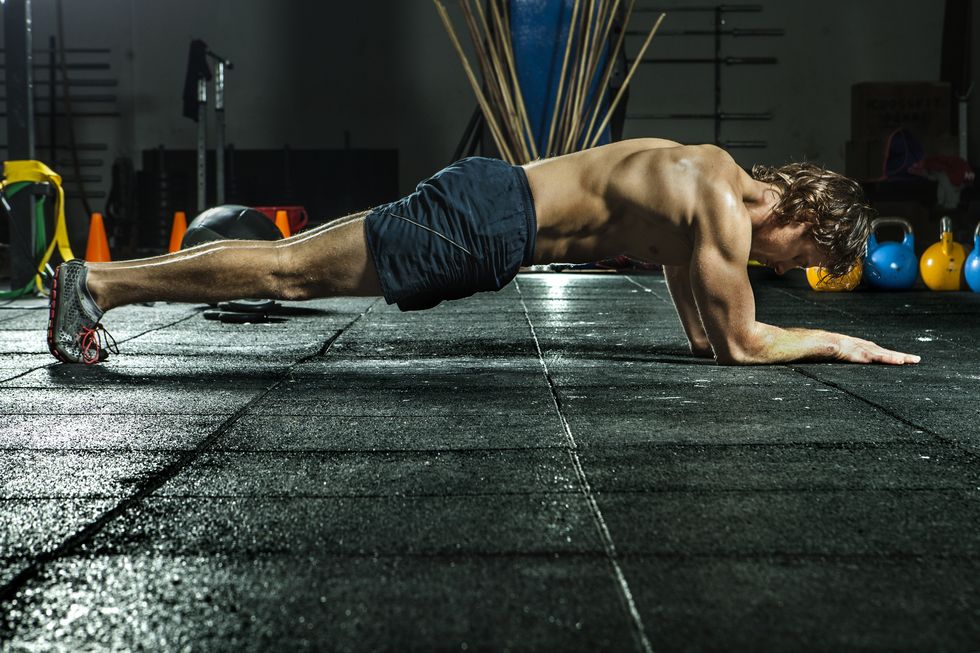 athletic man doing the plank for abs and core