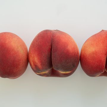 a row of white peaches on white surface